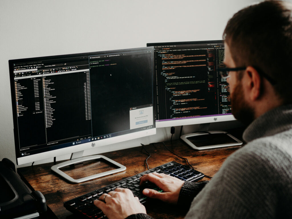 criteria in selecting outsourced it company 15 man working on computers coding