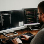 Man Working on Computers Coding