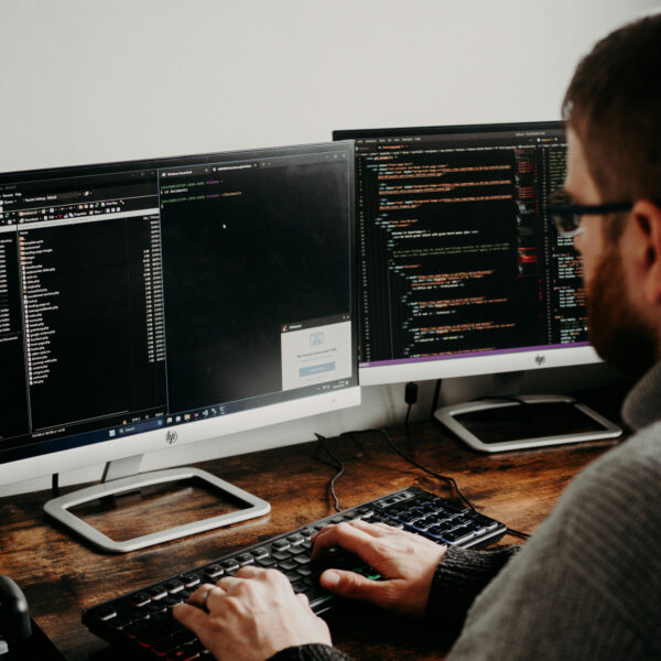 Man Working on Computers Coding