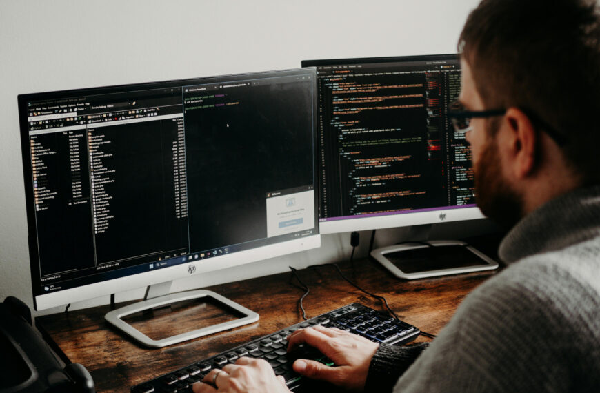Man Working on Computers Coding