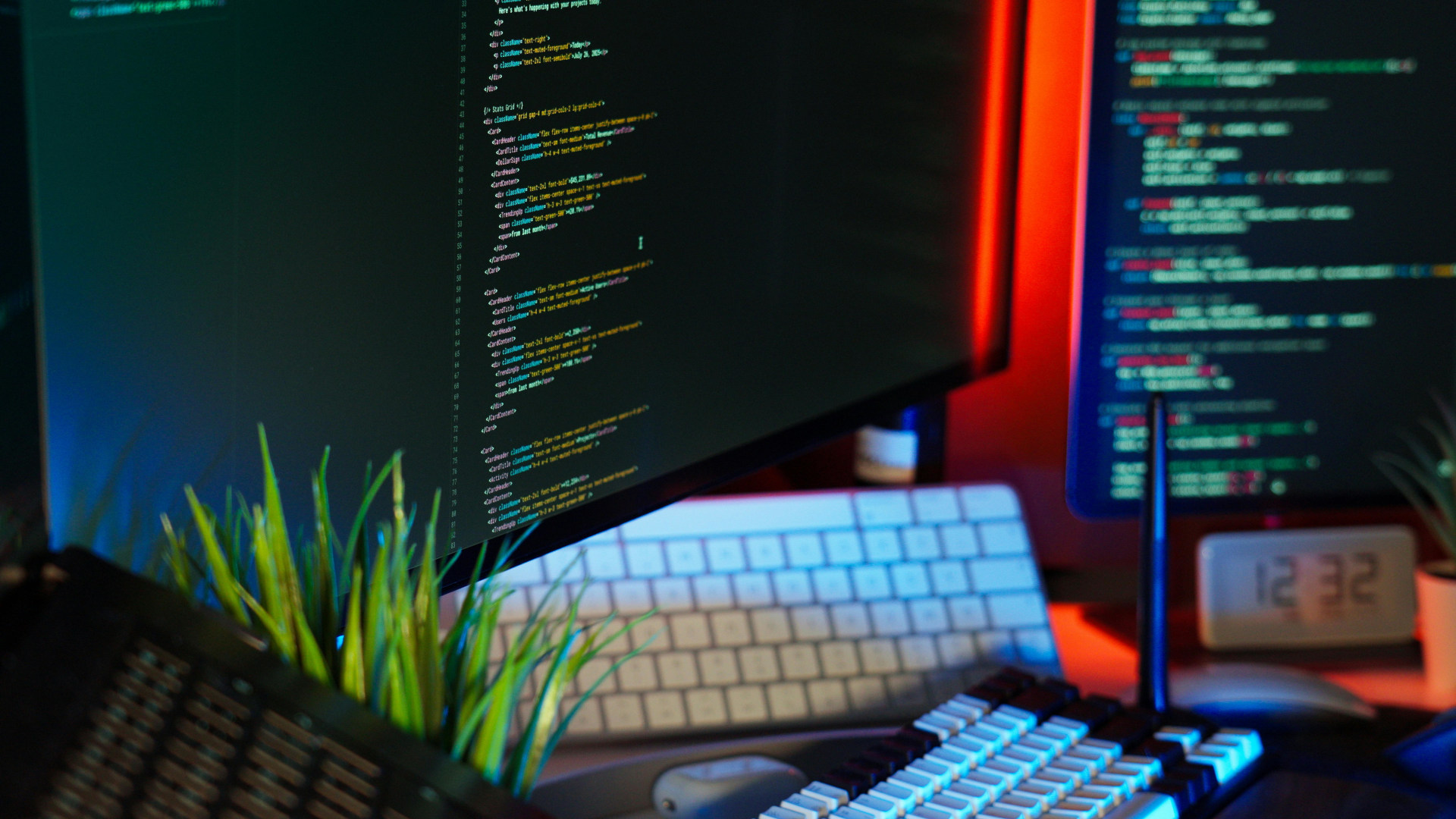 Modern Workspace with Coding Screens and Keyboard